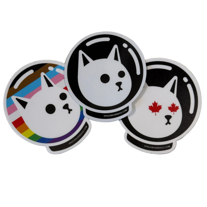 Three circular stickers with cat designs on a white background